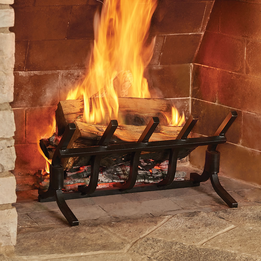 Fireplace grate that generates more than twice the heat output of a horizontal model with only half the wood and none of the smoke. The grate enables the radiant heat emitted by embers to project outward into one
